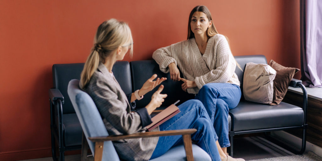 Image of psychotherapist talking to individual with symptoms of anxiety and panic